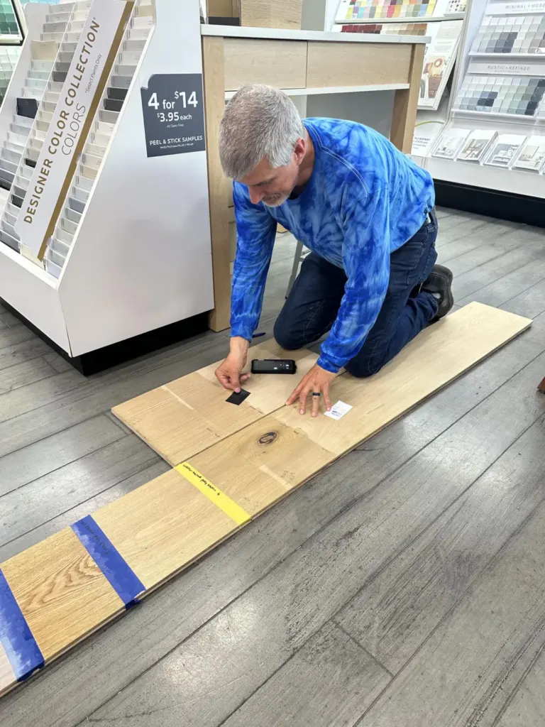 Bryan comparing wood samples for a custom stain color match in Baton Rouge